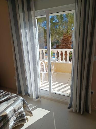 a bedroom with a sliding glass door to a patio at Dúplex El Divino in Los Alcázares