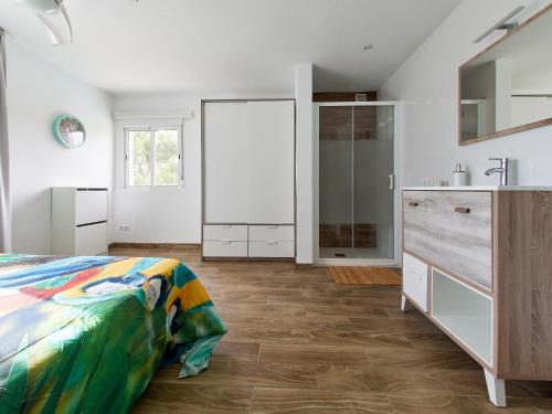 a white bedroom with a bed and a sink at Naizan in L'Ametlla de Mar