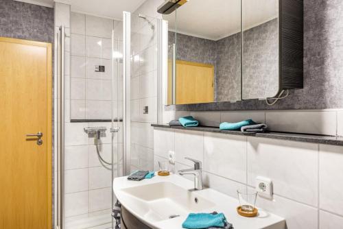 a bathroom with a sink and a shower at Ferienwohnung Göpfert in Weyhers