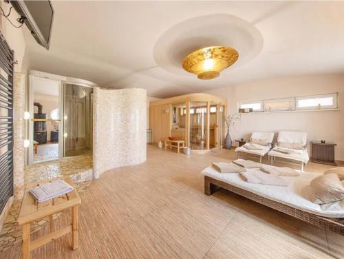 a large living room with a bed and a couch at Ferienhaus Kuhweid in Drochtersen