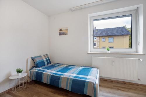 a bedroom with a bed and a window at Allgäu Space in Marktoberdorf