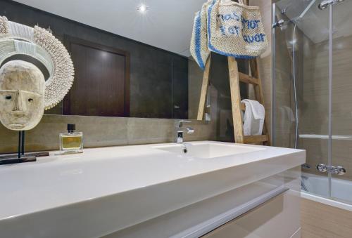 a bathroom with a white sink and a mirror at Modern frontline beach - Estepona in Estepona