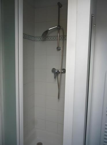 a shower with a shower head in a bathroom at Gîte Le Guerichet in Betton