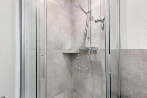 a shower with a glass door in a bathroom at Fewo am Mühlenbach in Wehr