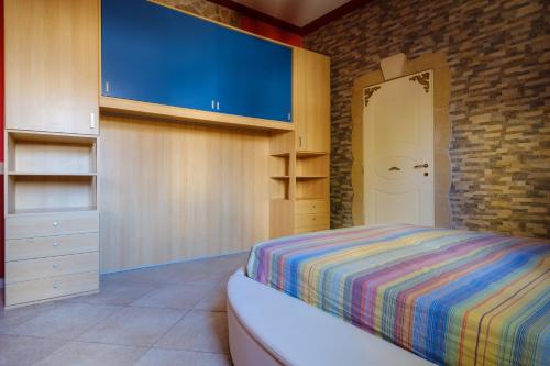 a bedroom with a bed and a brick wall at Villa Chanel in Monteroni di Lecce