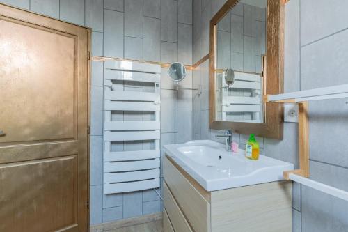 a bathroom with a sink and a mirror at La Pause Picarde - Baie De Somme 2 in Franleu