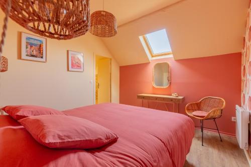 a bedroom with a bed with red sheets and a window at La Pause Picarde - Baie De Somme 2 in Franleu