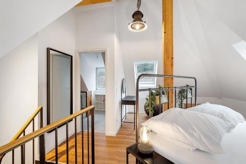 a bedroom with a metal bed and a staircase at Historische Werkstatt in Gernsbach