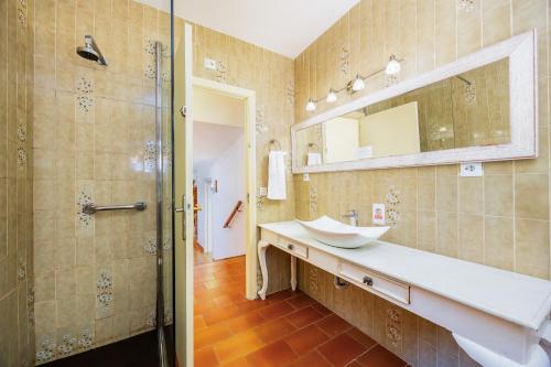 a bathroom with a sink and a mirror and a shower at Es Puig de Ses Coves in Santa Eugenia