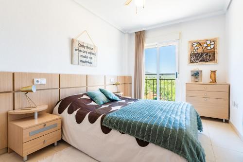 a bedroom with a large bed and a window at Duplex Torre La Sal Magic World in Cabanes