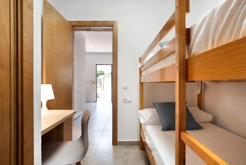 a bedroom with a bunk bed and a desk at Villa Montenmedio - Carmelo in El Soto
