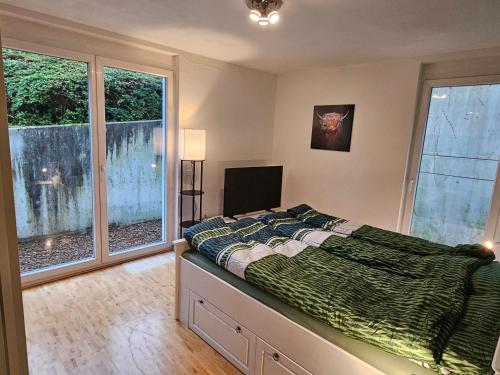 a bedroom with a bed and a large window at Ferienwohnung Steni in Wehr