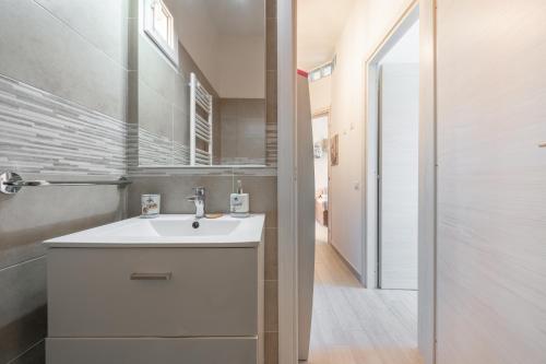 a bathroom with a white sink and a mirror at Gemma Piccolino in Villasimius