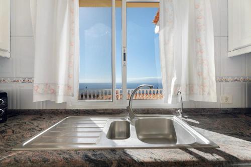 a kitchen sink with a view of a window at House Carla Private Pool Heated in Puerto de Santiago