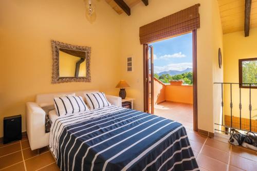 a bedroom with a bed and a large window at Estrella in Son Serra de Marina
