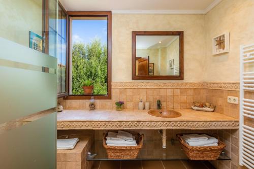 a bathroom with a sink and a mirror at Estrella in Son Serra de Marina