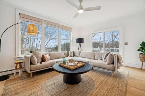 a living room with a couch and a table at 3 Mins to York Beach Large Deck Water View in York