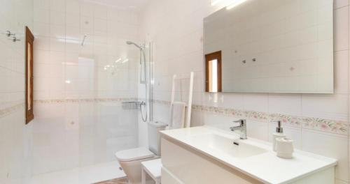 a bathroom with a sink and a shower and a toilet at Villa Hort de Can Rafalet in Ses Salines