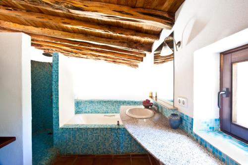 a bathroom with a tub and a toilet in it at Villa Can Rafal Ibiza in Sant Josep de sa Talaia