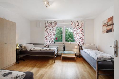 a living room with two beds and a window at Ferienwohnung Sonnendeck in Laupheim