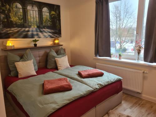 a bedroom with a bed with two pillows on it at Jmr in Uelzen