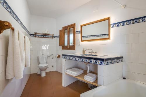 a bathroom with a sink and a toilet at Casa Belmonte in Bubión