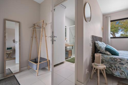 a bedroom with a bed and a mirror at Les loges de Pérelle in Chozeau