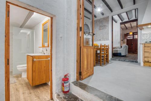 a bathroom with a sink and a toilet in a room at La casa de la Sariera in Jávea