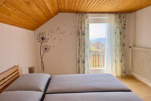 a bedroom with a bed and a window at Ferienhaus "Kleine Auszeit" in Tieschen
