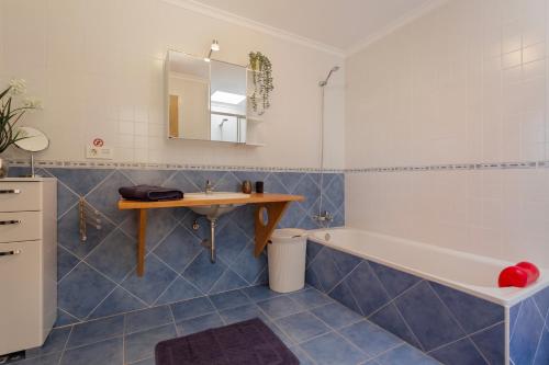 a bathroom with a sink and a tub and a table at El refugio in La Oliva