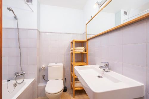 a bathroom with a sink and a toilet and a mirror at Cas Sitger in Felanitx