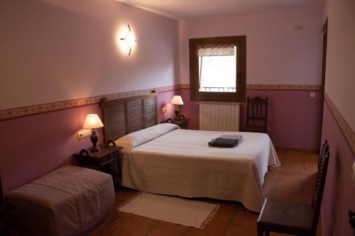 a bedroom with a bed and a chair and a window at Lokate 5 Habitaciones in Aia