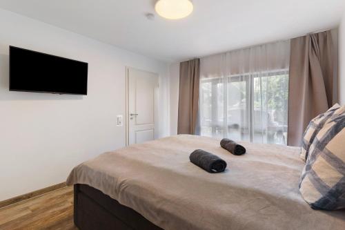 a bedroom with a bed with two pillows on it at Ferienwohnung Santa Gabriella in Herbolzheim