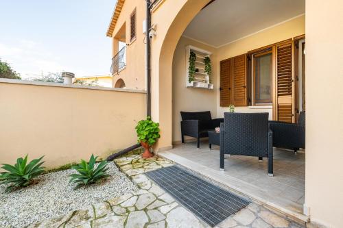 a patio of a house with chairs and a table at Queen's House in Pula