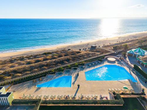 an overhead view of a beach and a swimming pool at Pestana Alvor Beach Villas Seaside Resort in Alvor