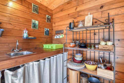 a kitchen with wooden walls and a sink at Awa Natura in Aigues