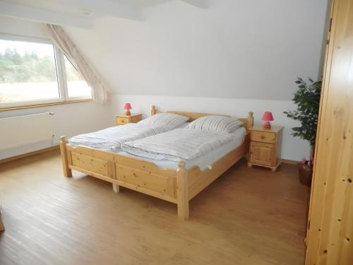a bed in a room with a window at Ferienhaus Drelsdorfer Forst in Drelsdorf