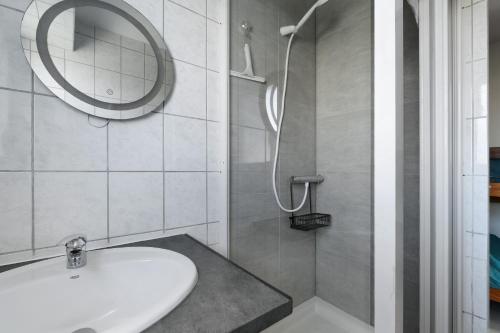 a bathroom with a sink and a shower at Appartement du Golf - Pornic 2 in Pornic
