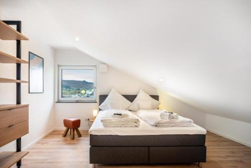 a bedroom with a bed in the attic at Moselbude Kröv mit Sauna in Kröv