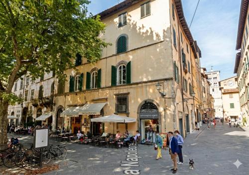 a group of people walking down a street with a building at Noble Floor - Panoramic Luxury Apartment in Lucca
