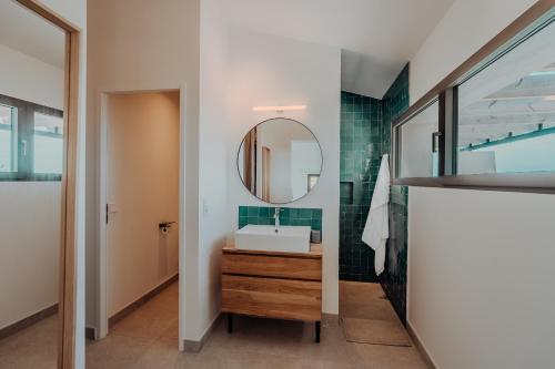 a bathroom with a sink and a mirror at La Thébaïde in Cargèse