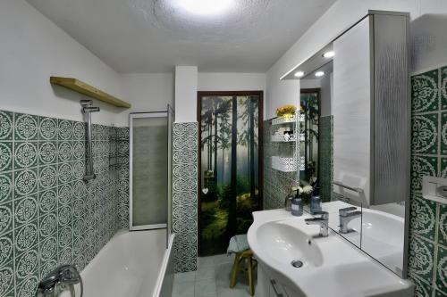 a bathroom with a white sink and a shower at Maison Wanda La Salle in La Salle