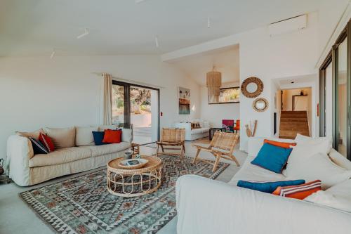 a living room with two couches and a table at La Thébaïde in Cargèse