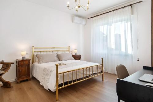 a bedroom with a bed and a desk and a window at Dante210 in Cassina Rizzardi