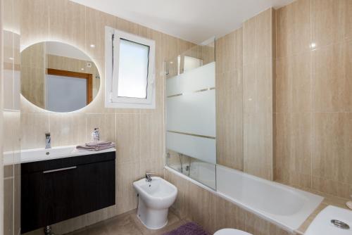 a bathroom with a sink and a toilet and a mirror at Atico Duplex con terraza in Manilva