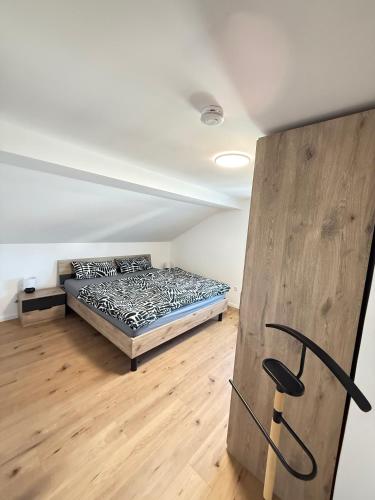 a bedroom with a bed and a wooden floor at Ferienwohnung Kastellaun in Kastellaun