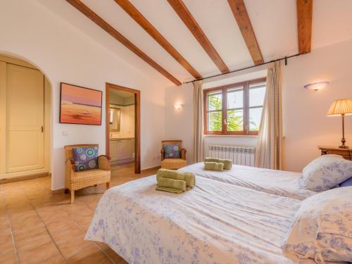 a large bedroom with a large bed and a window at Ses Mires in Santanyi
