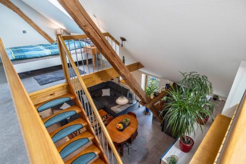 an overhead view of a living room with a spiral staircase at Offene Galerie-Fewo auf 2 Etagen in Bad Gandersheim