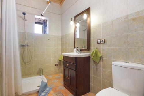 a bathroom with a toilet and a sink and a shower at Casa los Javieles in Puerto del Rosario