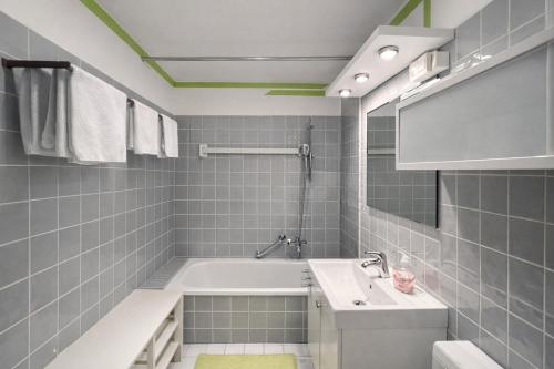 a bathroom with a bath tub and a sink at Waldquartier in Schönwald